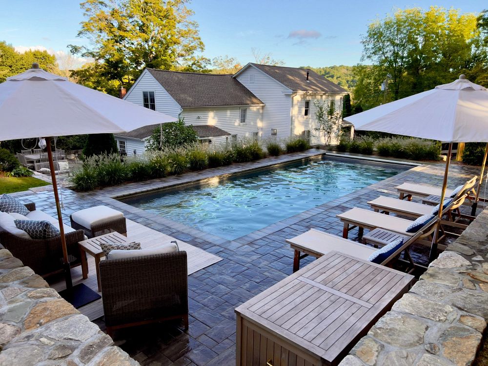 fiberglass pool in Connecticut backyard installed on a hill