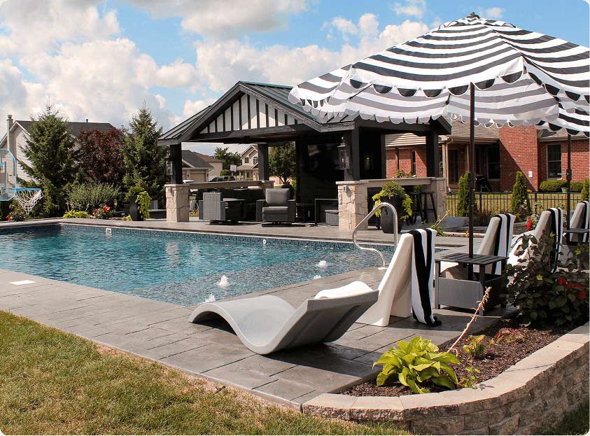 tranquil backyard with stone work, water features and inground pool
