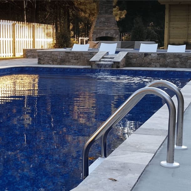 Deep blue inground pool with a swirling, ocean-inspired pattern